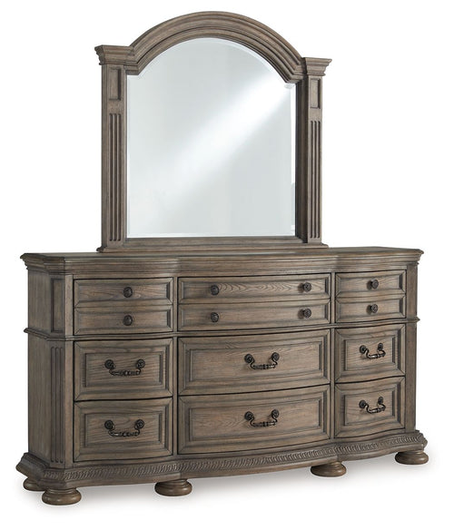 Light brown wooden dresser with arched mirror and multiple drawers, dark hardware