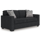 Coal fabric sofa with nailhead-trimmed arms and two heather gray throw pillows