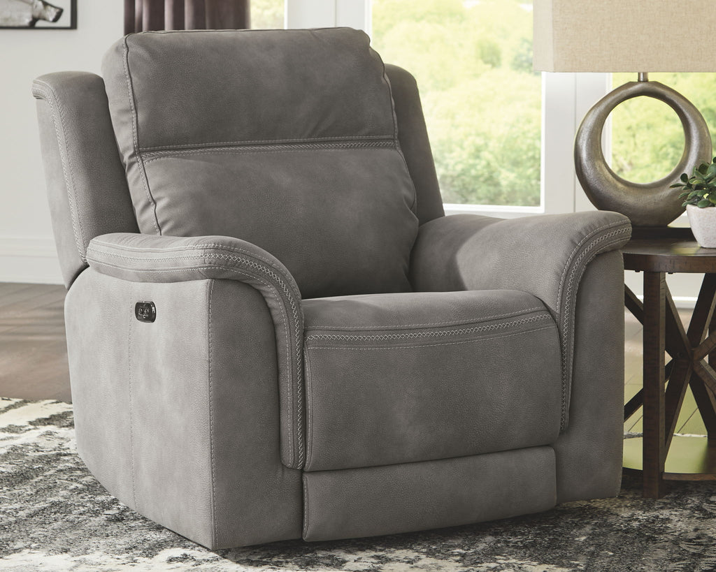 Slate gray power recliner chair with wide armrests and relaxed seat pad