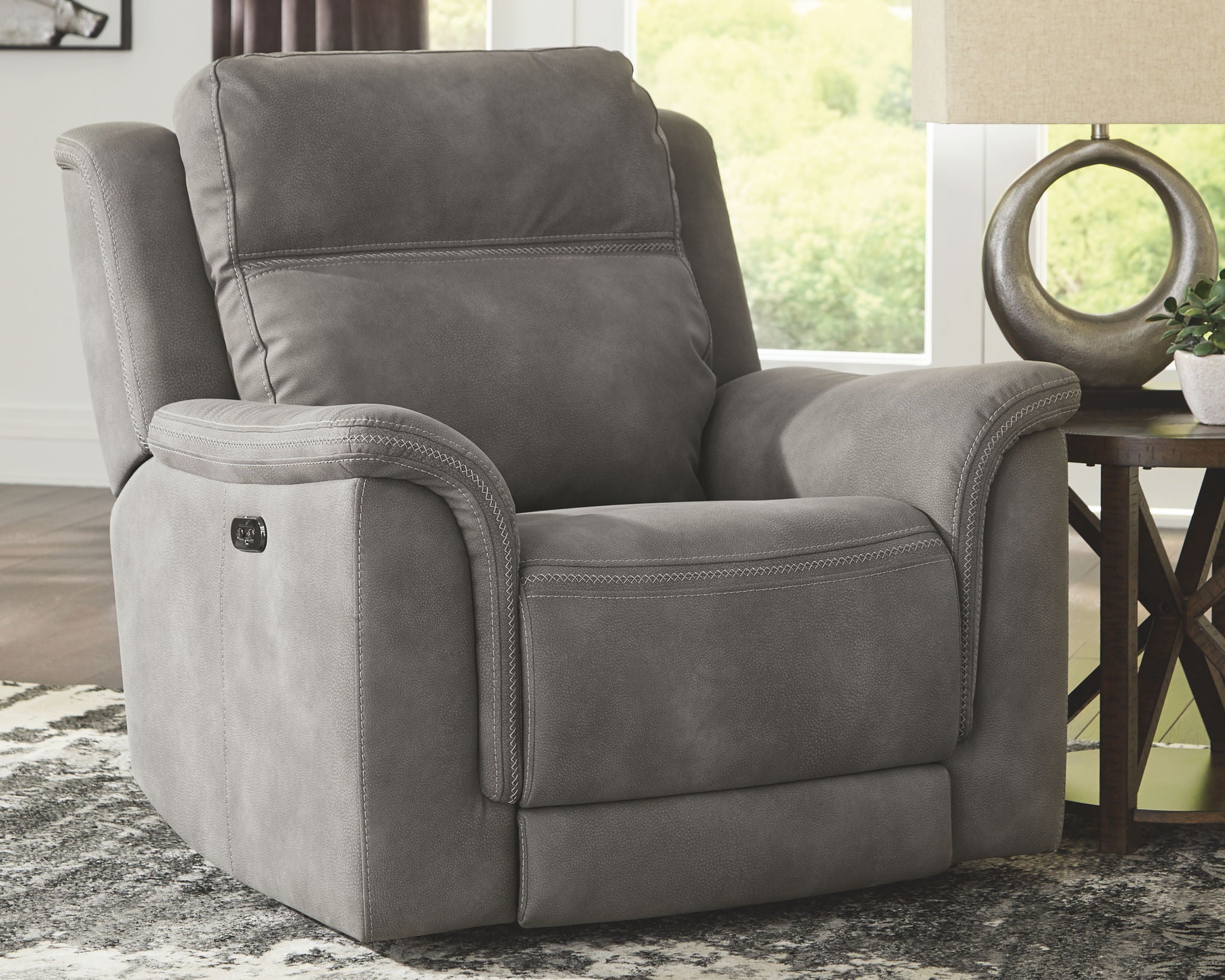 Slate gray power recliner chair with wide armrests and relaxed seat pad