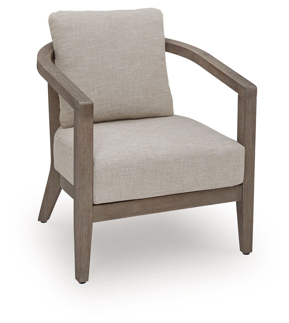 Outdoor armchair with beige upholstered seat and back cushions, rounded wooden arms