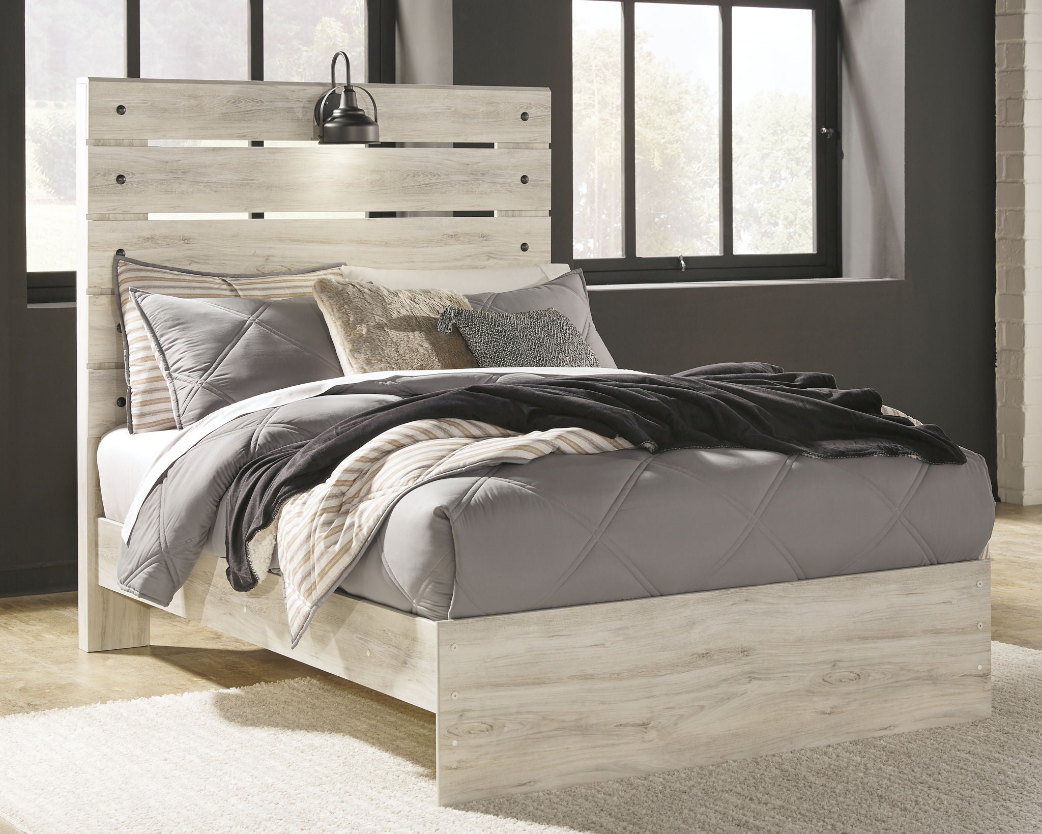 Light wood panel bed with two side drawers and upholstered bedding in gray and beige tones