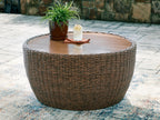 Round cocktail table with woven wicker base and wooden tabletop