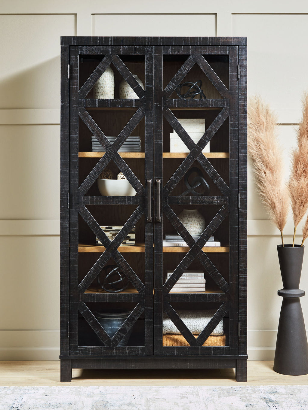 Black accent cabinet with X-pattern doors and multiple shelves