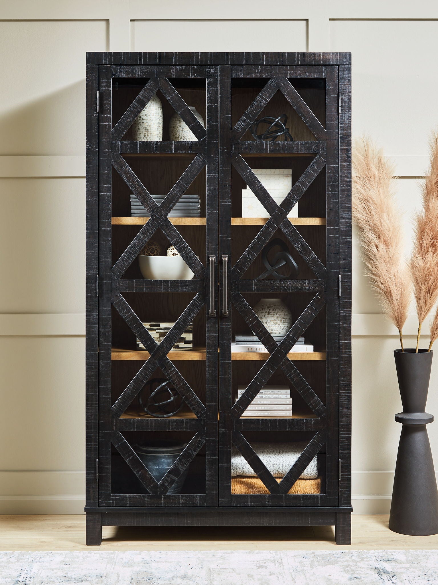 Black accent cabinet with X-pattern doors and multiple shelves