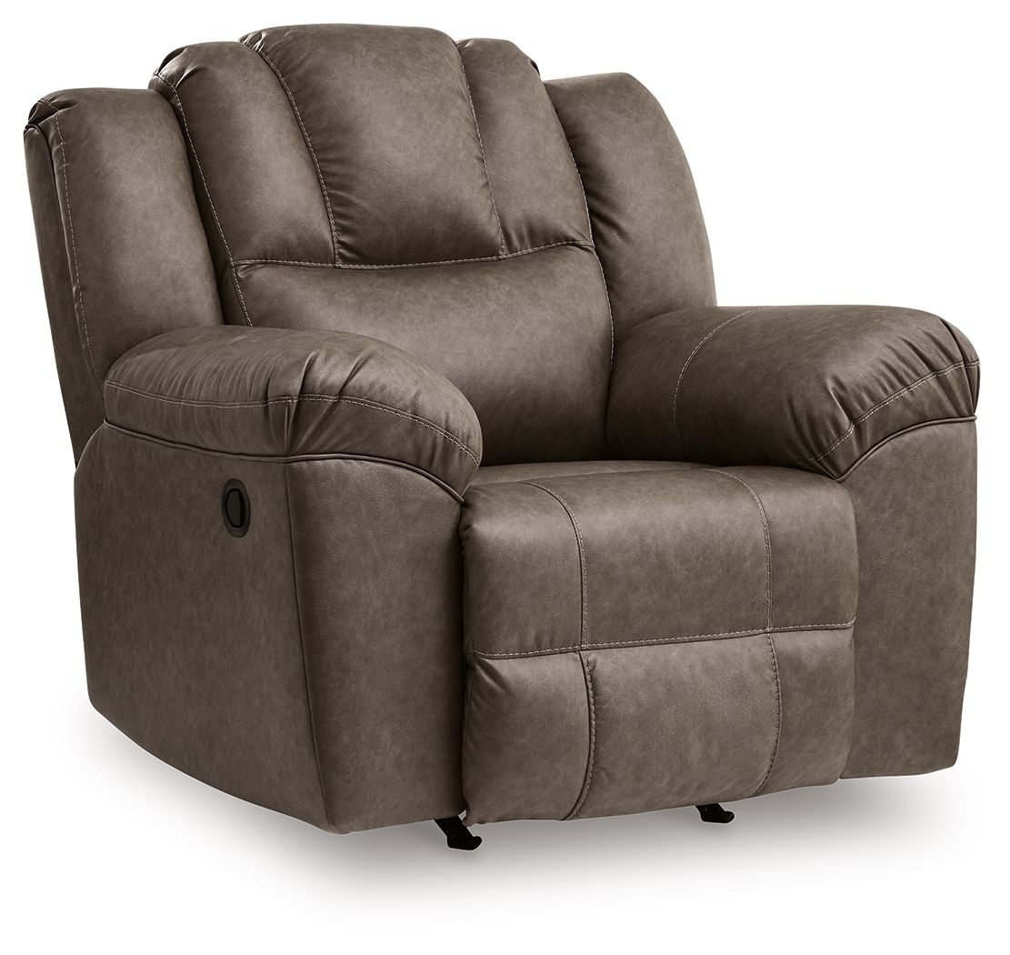 Dark brown rocker recliner chair with cushioned arms, tufted back, and side control