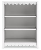 White bookcase with scalloped top and bottom trim, three open shelves, flat back