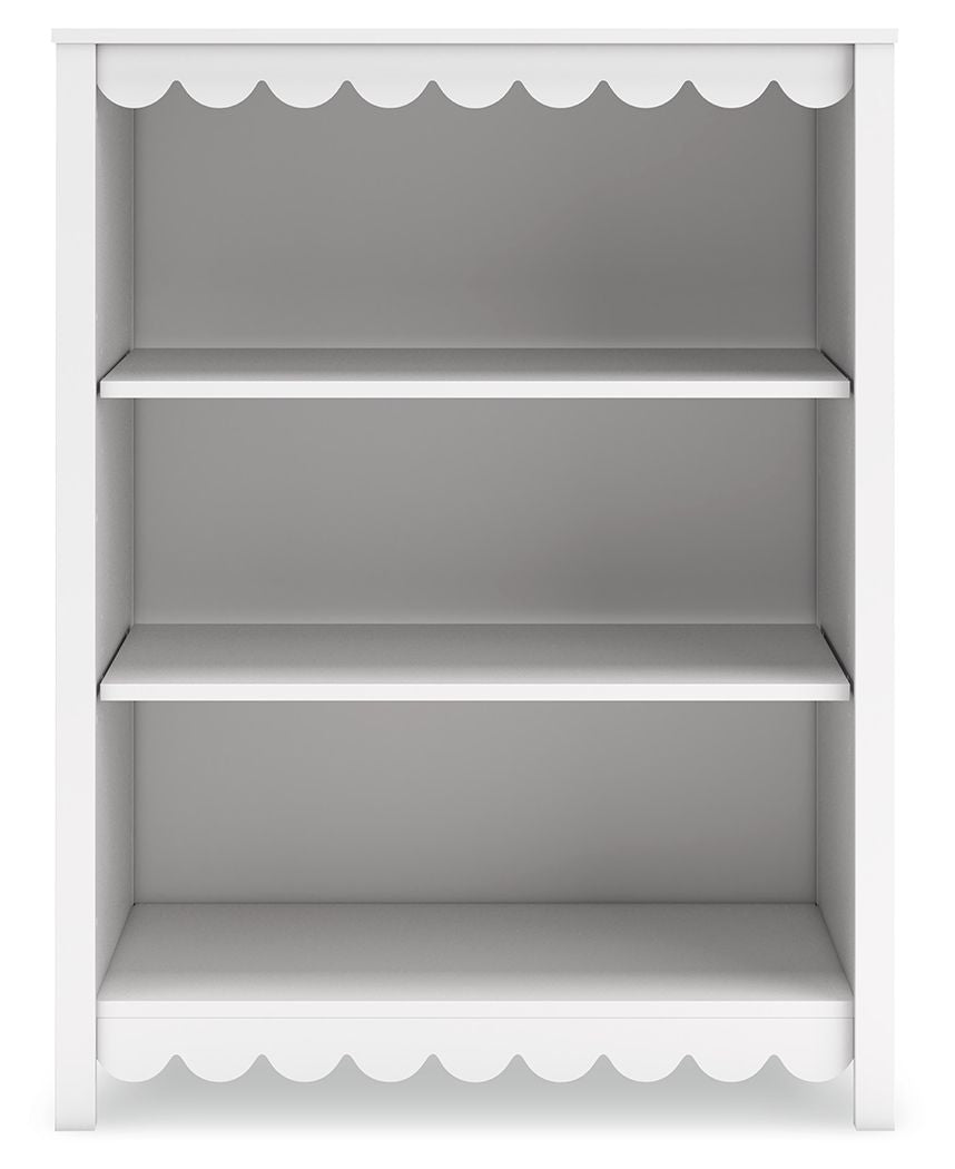 White bookcase with scalloped top and bottom trim, three open shelves, flat back