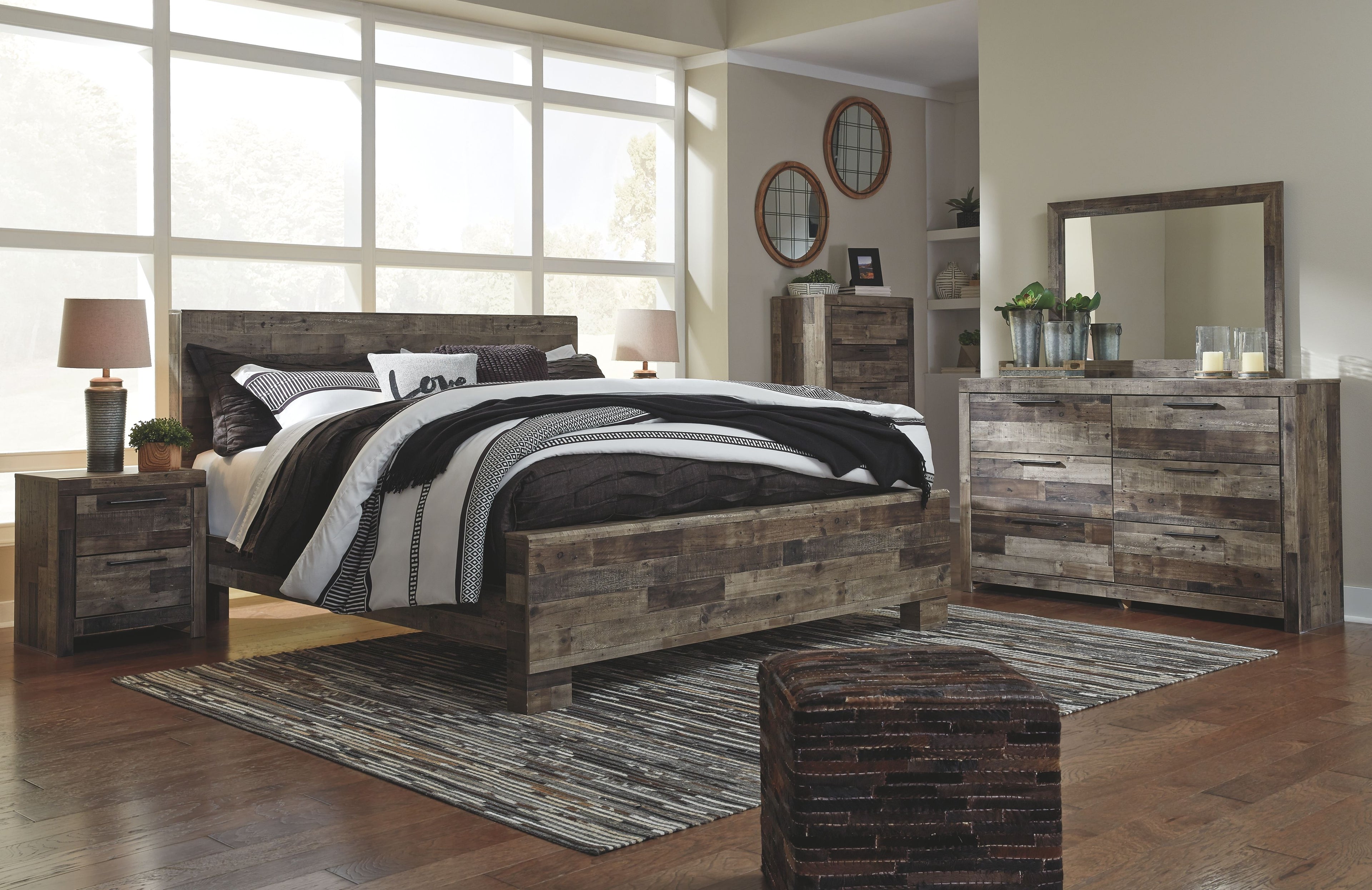 Panel bedroom set with panel bed and dresser with mirror in rustic gray wood with dark accents.