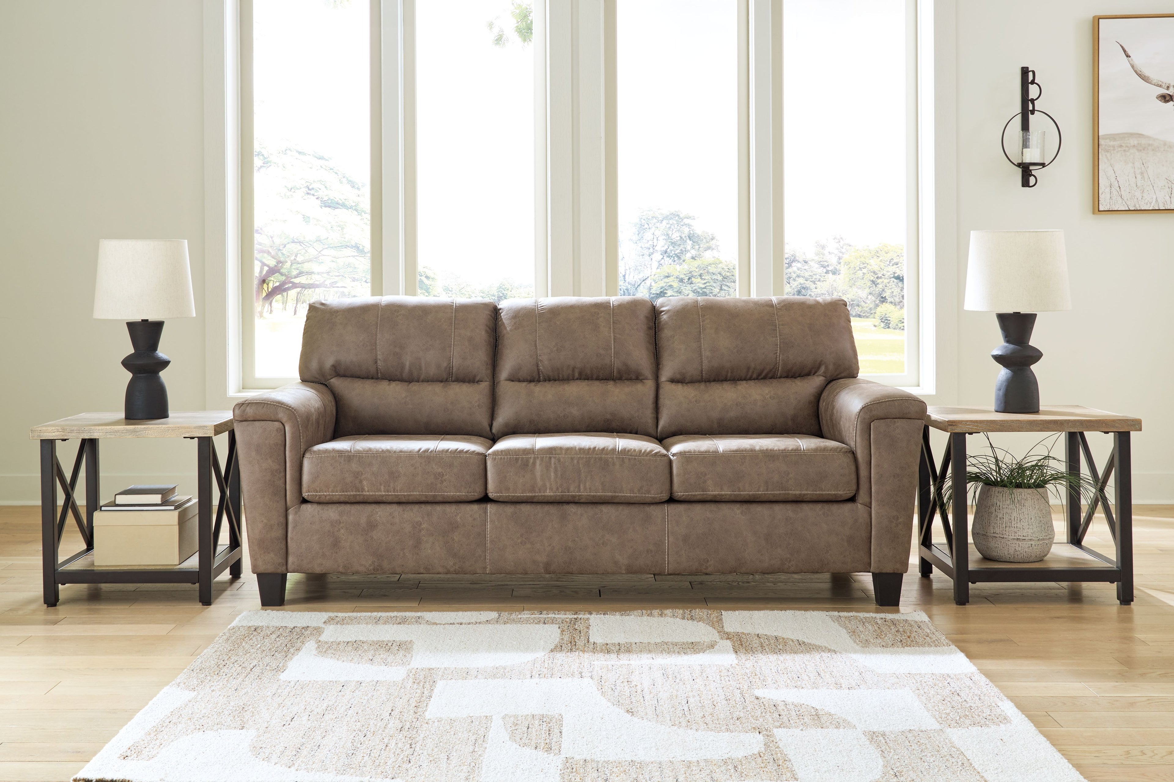Fossil fabric sofa with three-seat back cushions and padded arms on short legs