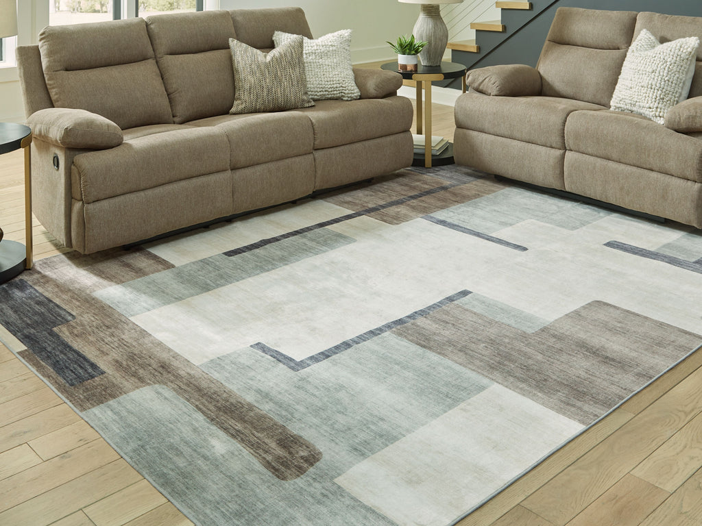 Beige and gray abstract washable area rug in living room on wood floor