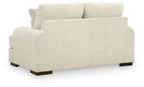 Light cream loveseat sofa with two seat cushions, square arms, short dark legs