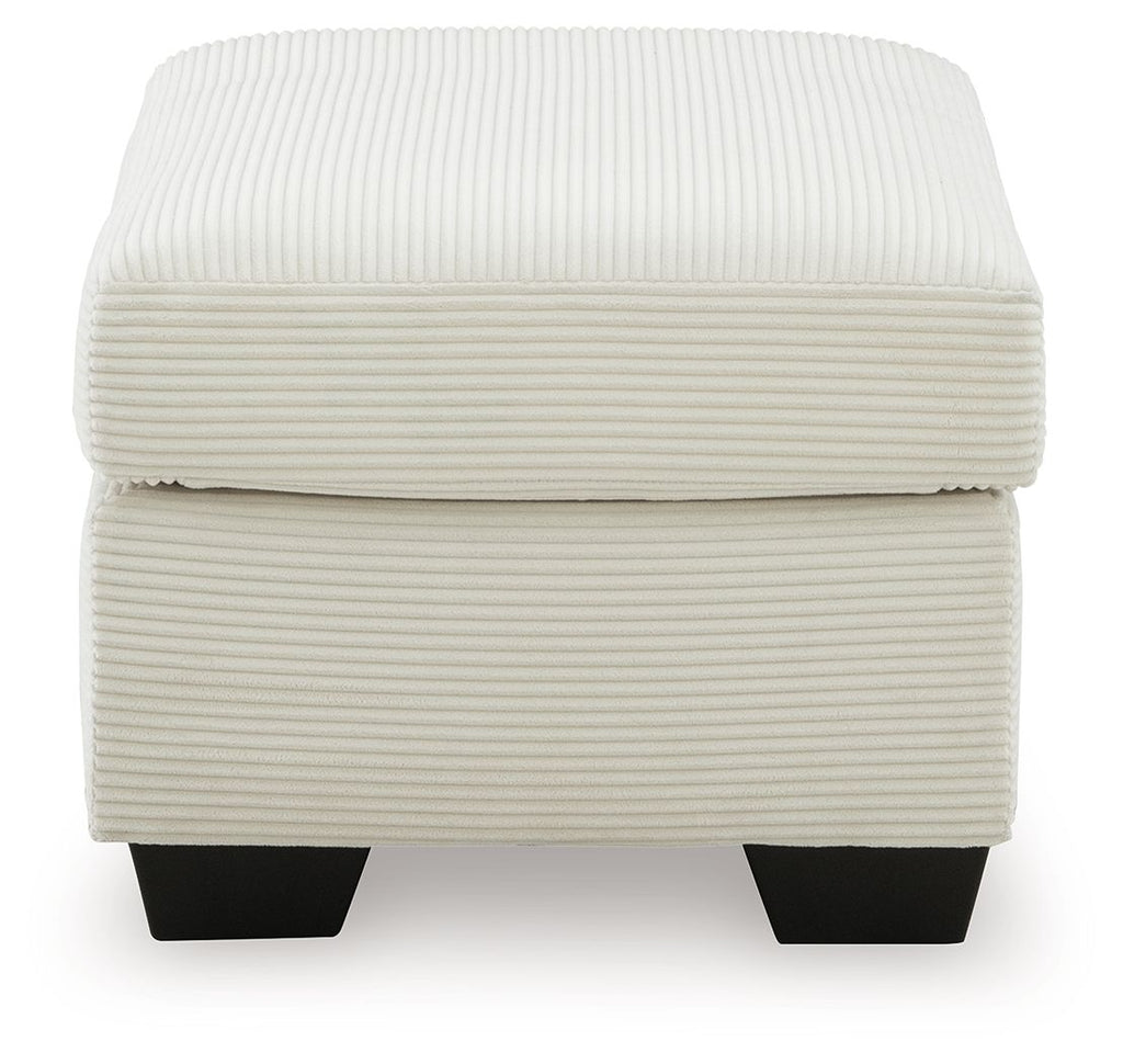 Cream upholstered ottoman with ribbed fabric, rounded lid, and dark square feet