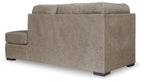 Corner chaise lounge with taupe fabric, square arms, and dark tapered legs.