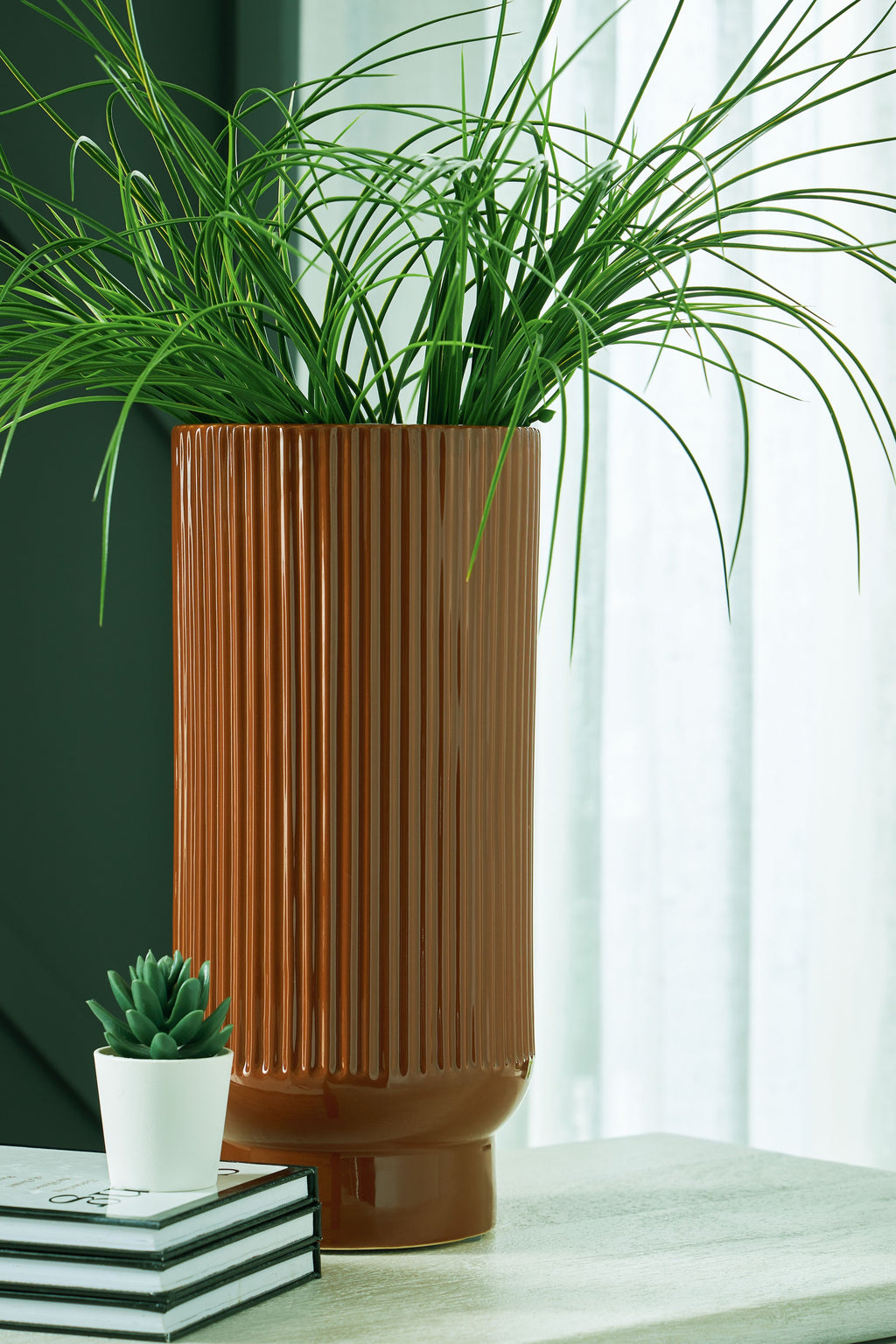 Dark brown ribbed ceramic vase on pedestal base
