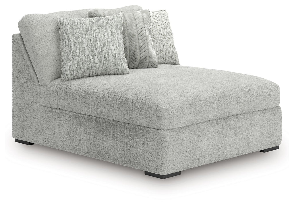 Oversized armless chaise in light gray textured fabric with two accent pillows