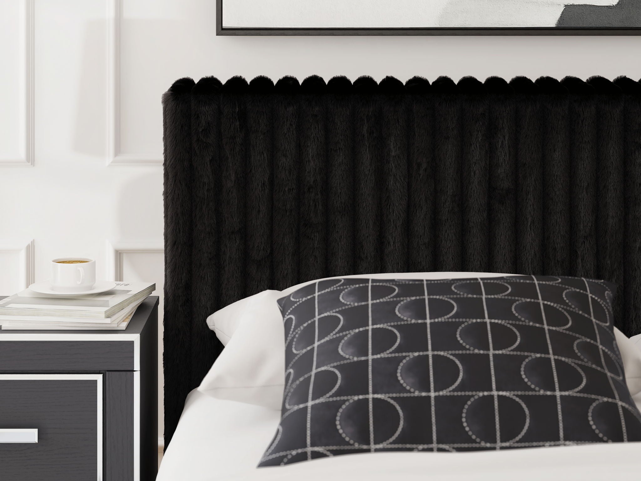 Black upholstered headboard and bed frame with patterned decorative pillow and bedding.
