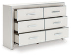 Six-drawer dresser in white finish with open drawers and silver bar pulls.