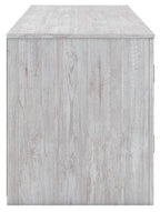 Light wood TV stand with flat top and door panels for fireplace storage