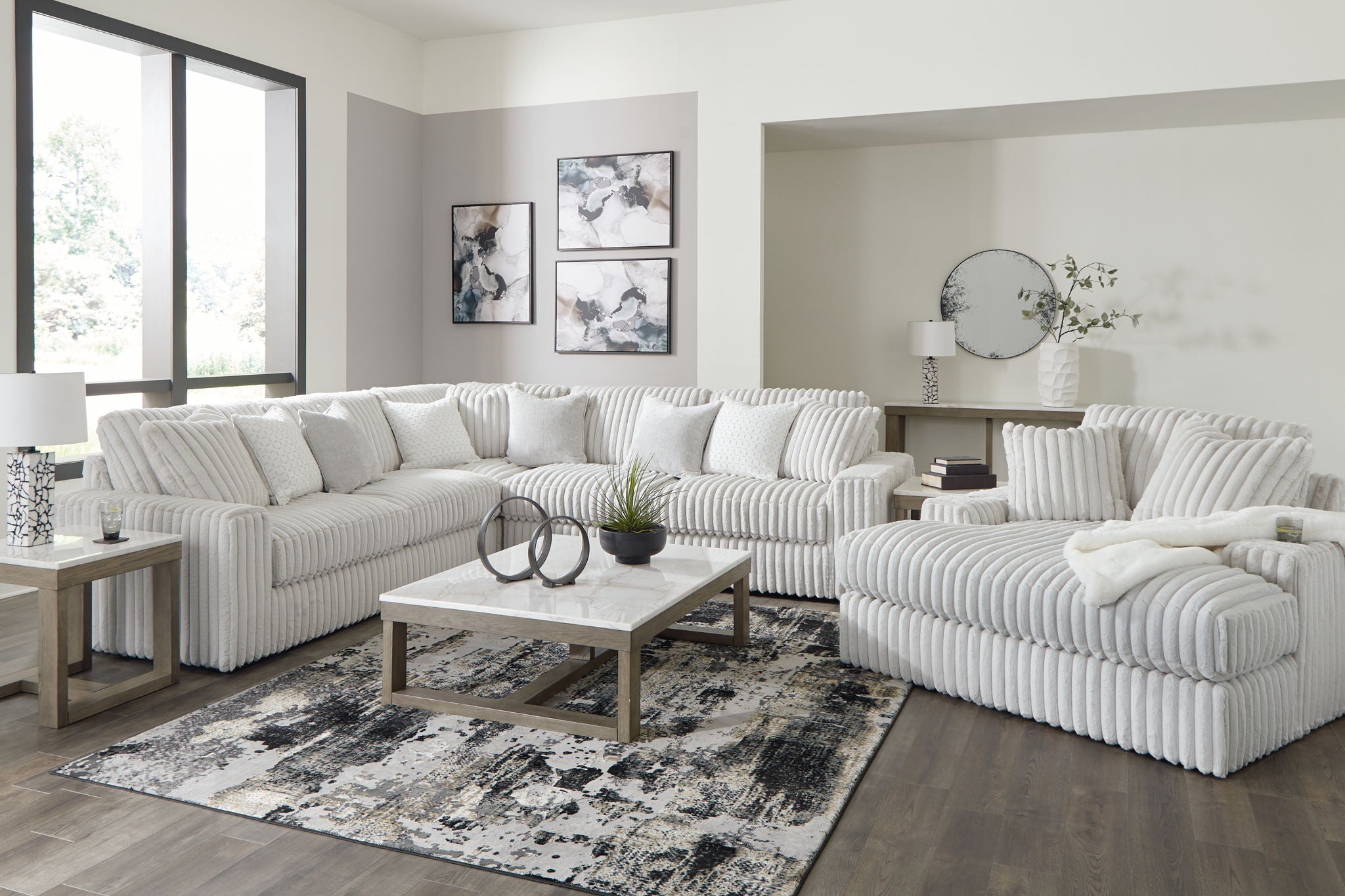 Gray sectional sofa with chaise, tufted cushions and ribbed track-arm design