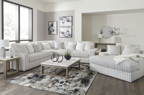 Gray sectional sofa with chaise, tufted cushions and ribbed track-arm design