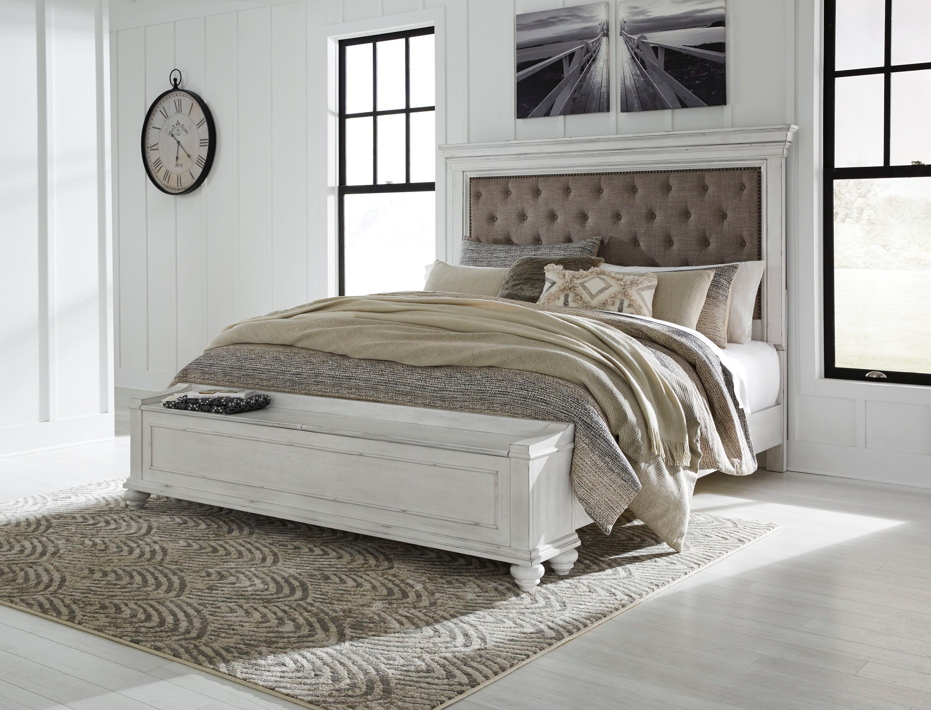 Upholstered panel bed in white with tufted taupe headboard and white frame