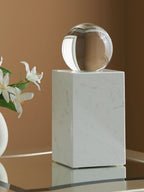 White glass sphere on white marble pedestal, tabletop display