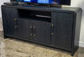 Large black TV stand with two cabinet doors and center open shelf, gold hardware