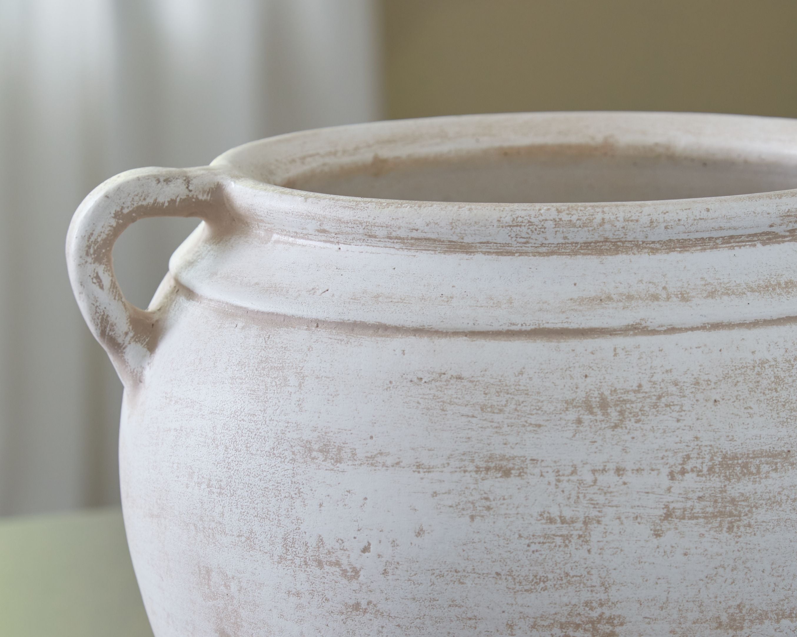 Off-white ceramic vase with wide mouth, side handle, distressed textured finish