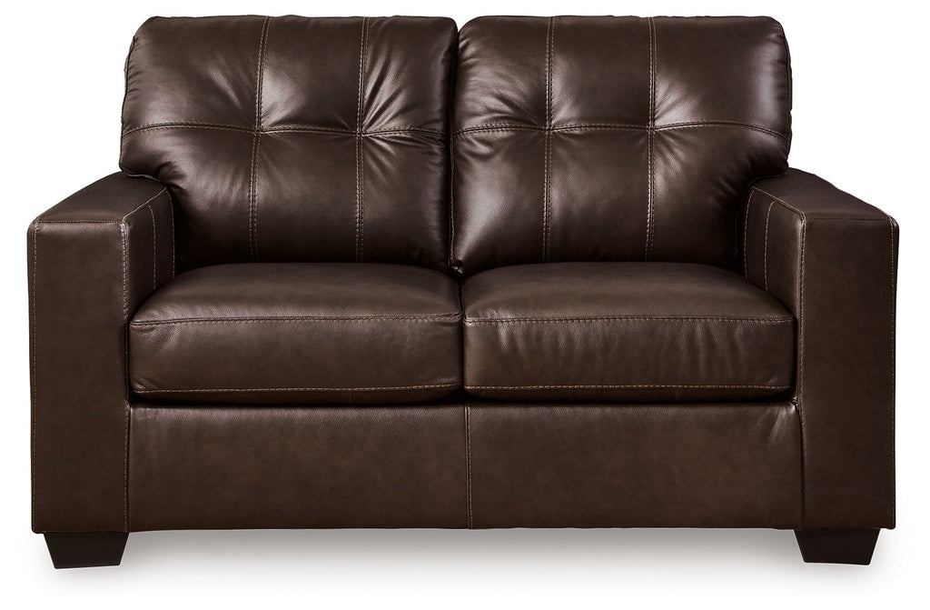 Dark brown leather-look loveseat with tufted back and two padded seat sections, squared arms
