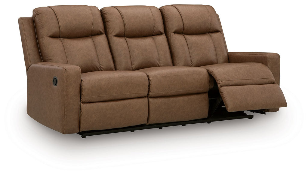 Light brown reclining sofa with pull-out ottoman on the right and tufted back cushions