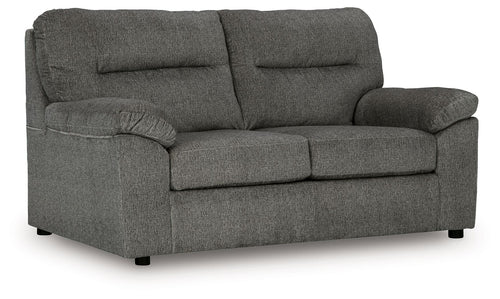 Dark gray fabric loveseat with rolled arms, two seat cushions, and tufted back