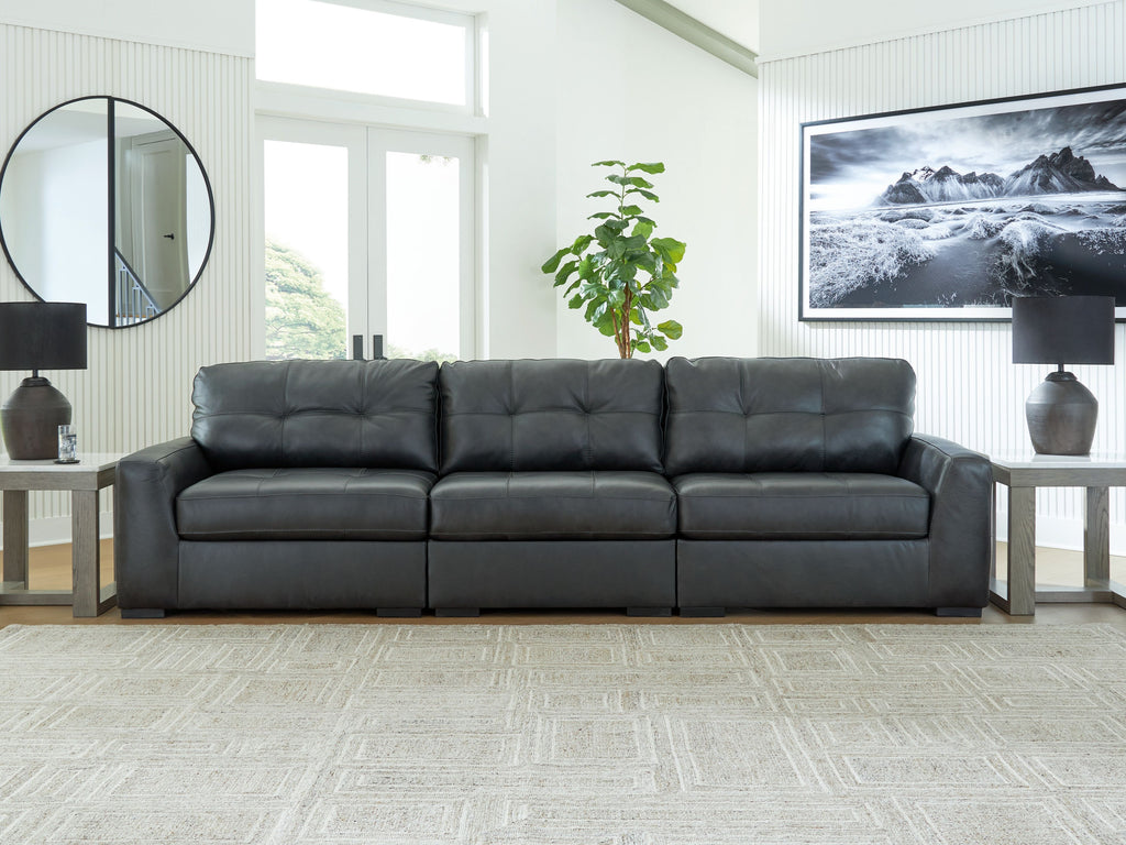 Three-seat sectional sofa with tufted back, squared arms, and dark upholstery