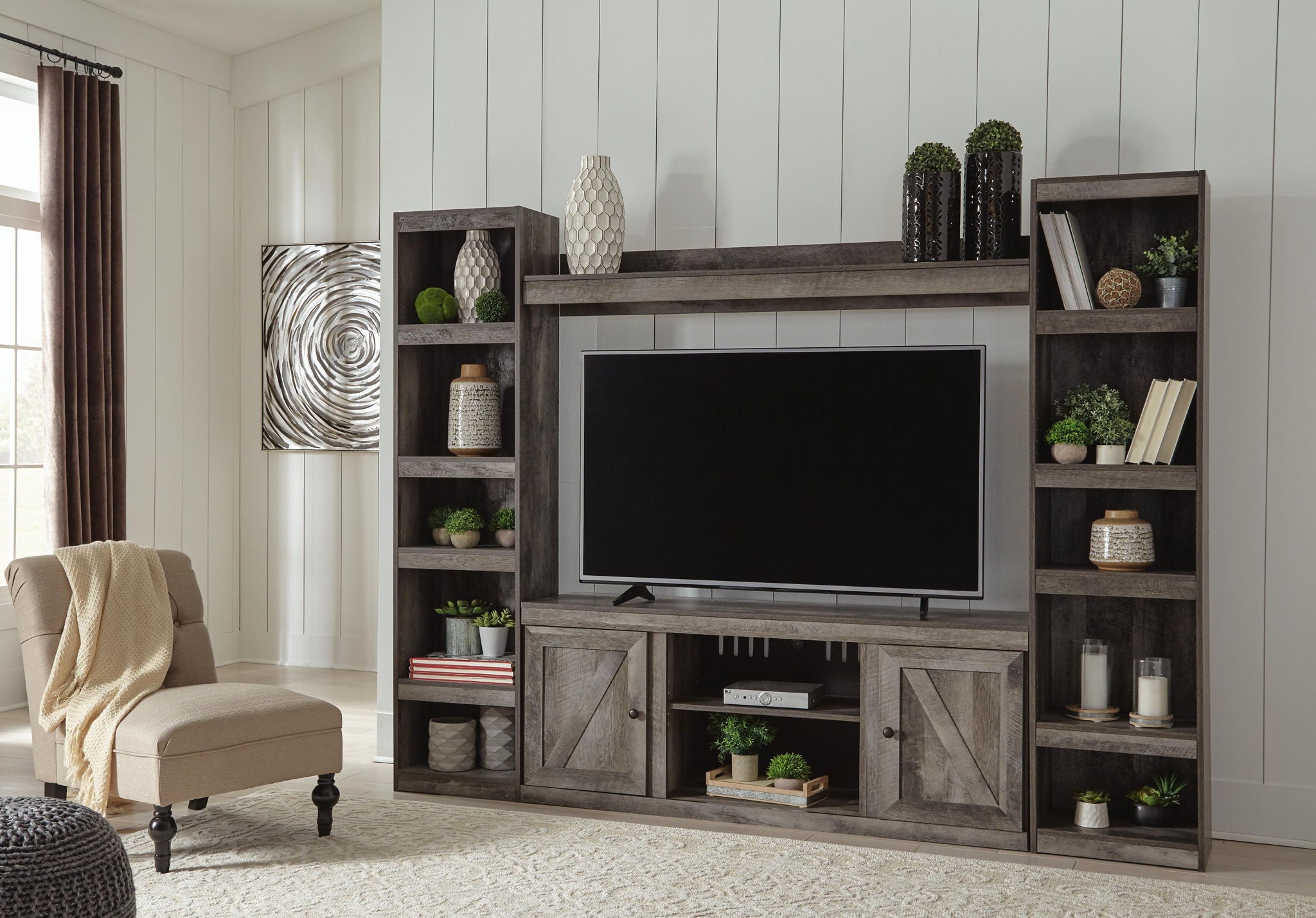 Gray entertainment center with TV mounted on mantel and open side shelves