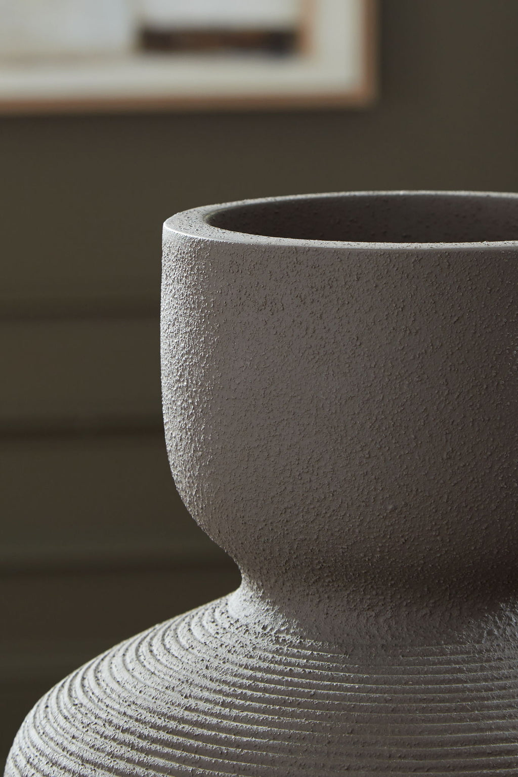 Dalsen vase close-up: dark brown stoneware with speckled texture and flared rim.