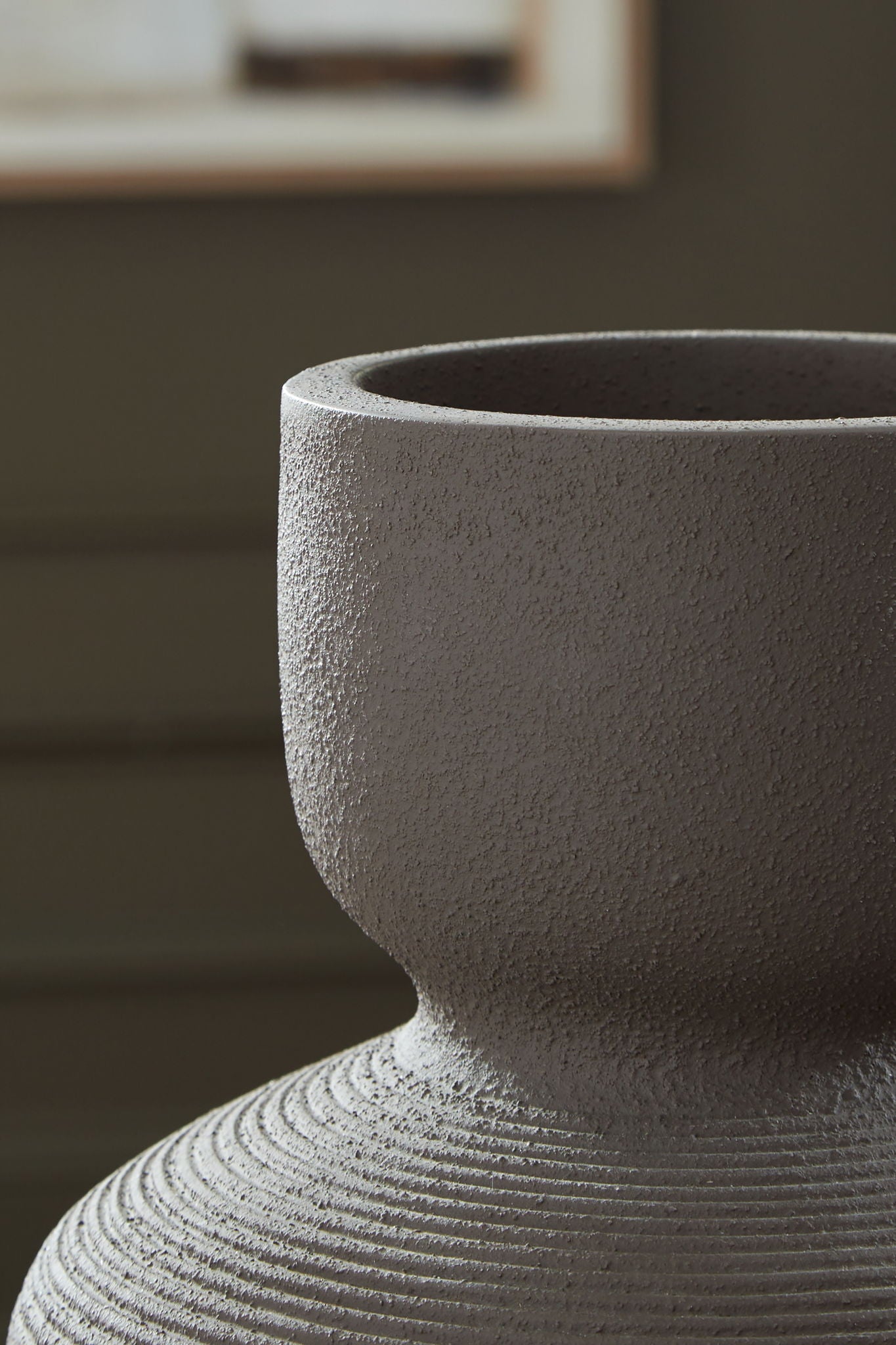 Dalsen vase close-up: dark brown stoneware with speckled texture and flared rim.