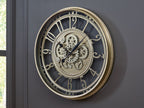 Champagne wall clock with mechanical gear dial and Roman numerals