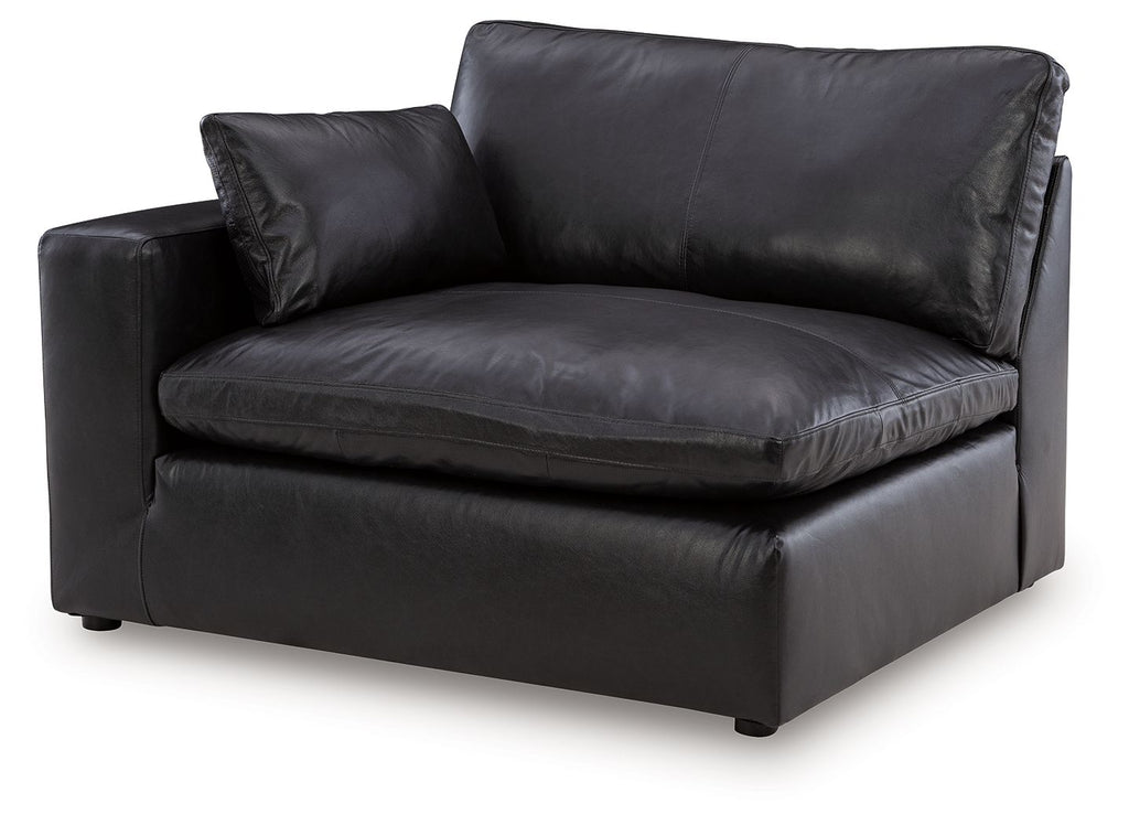 Black leather-look left-arm corner chair with padded seat, two cushions, sturdy base.