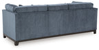 Navy fabric sofa with tufted arms and dark wooden legs