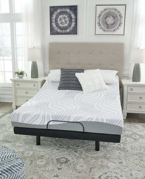 White memory foam mattress on dark platform bed, wave-pattern top