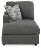 Dark gray corner chaise with patterned back cushion and boxed seat