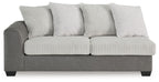 Grey sofa bed with ribbed seat, striped back pillows, and three back cushions