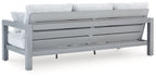 Hurley Park light gray outdoor sofa rear view with striped cushions and pillows