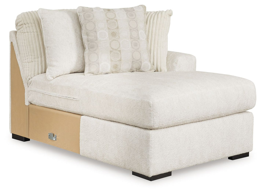 Ivory corner chaise sectional with track arms, tufted back, and patterned throw pillows