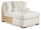 Ivory corner chaise sectional with track arms, tufted back, and patterned throw pillows