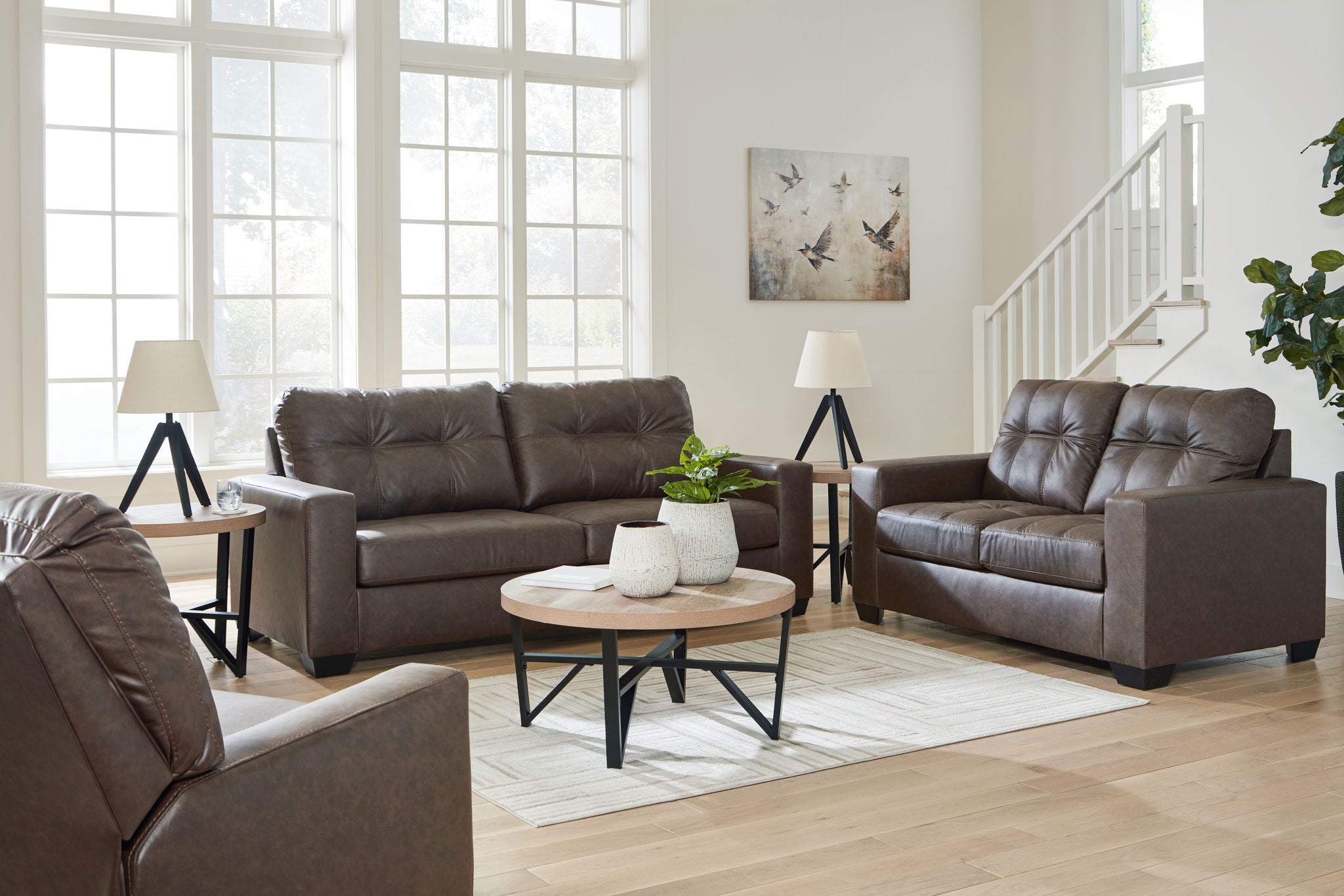 Dark brown leather-look loveseat and recliner chair with tufted backs and track arms