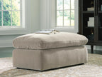 Light gray upholstered ottoman with stacked seat cushion and short legs
