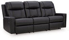Black reclining sofa with padded, tufted back cushions and segmented seat sections