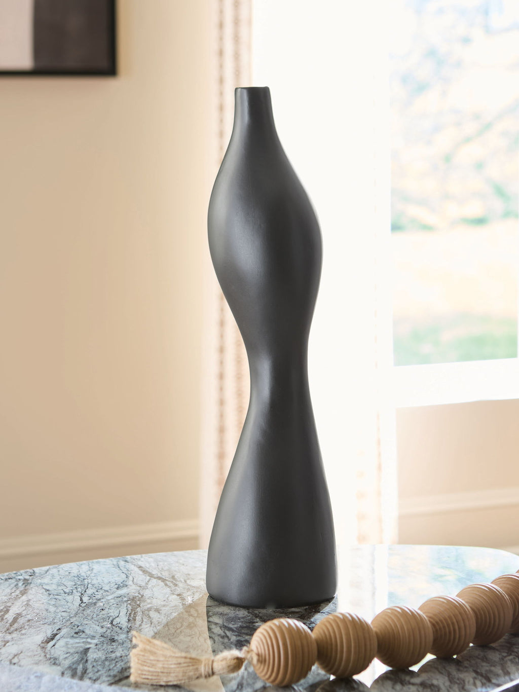 Black Judsen vase with tall curving form, narrow opening, and smooth matte finish.