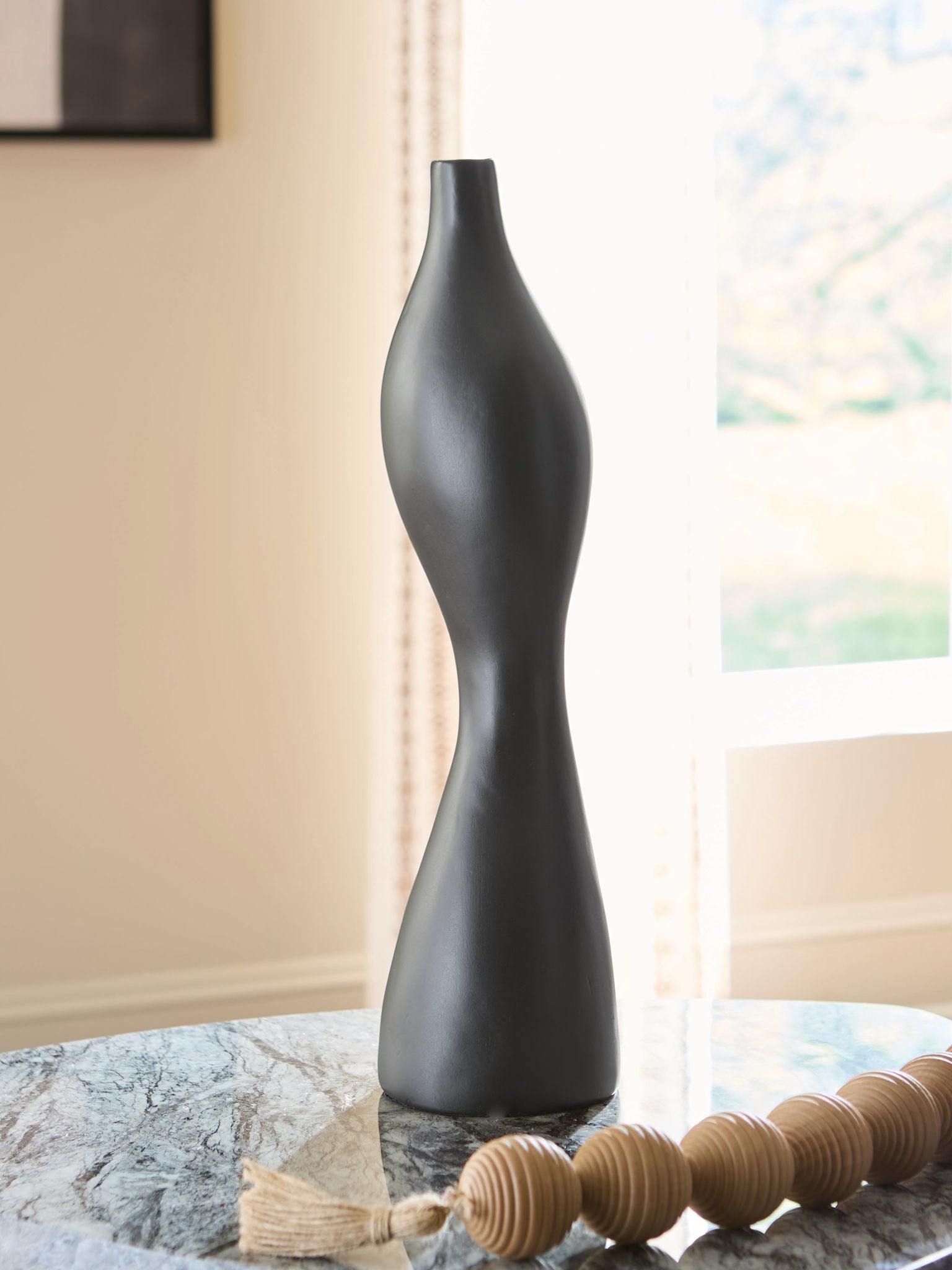 Black Judsen vase with tall curving form, narrow opening, and smooth matte finish.